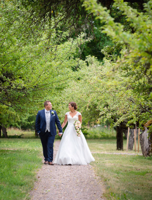 Brudpar går genom trädgården